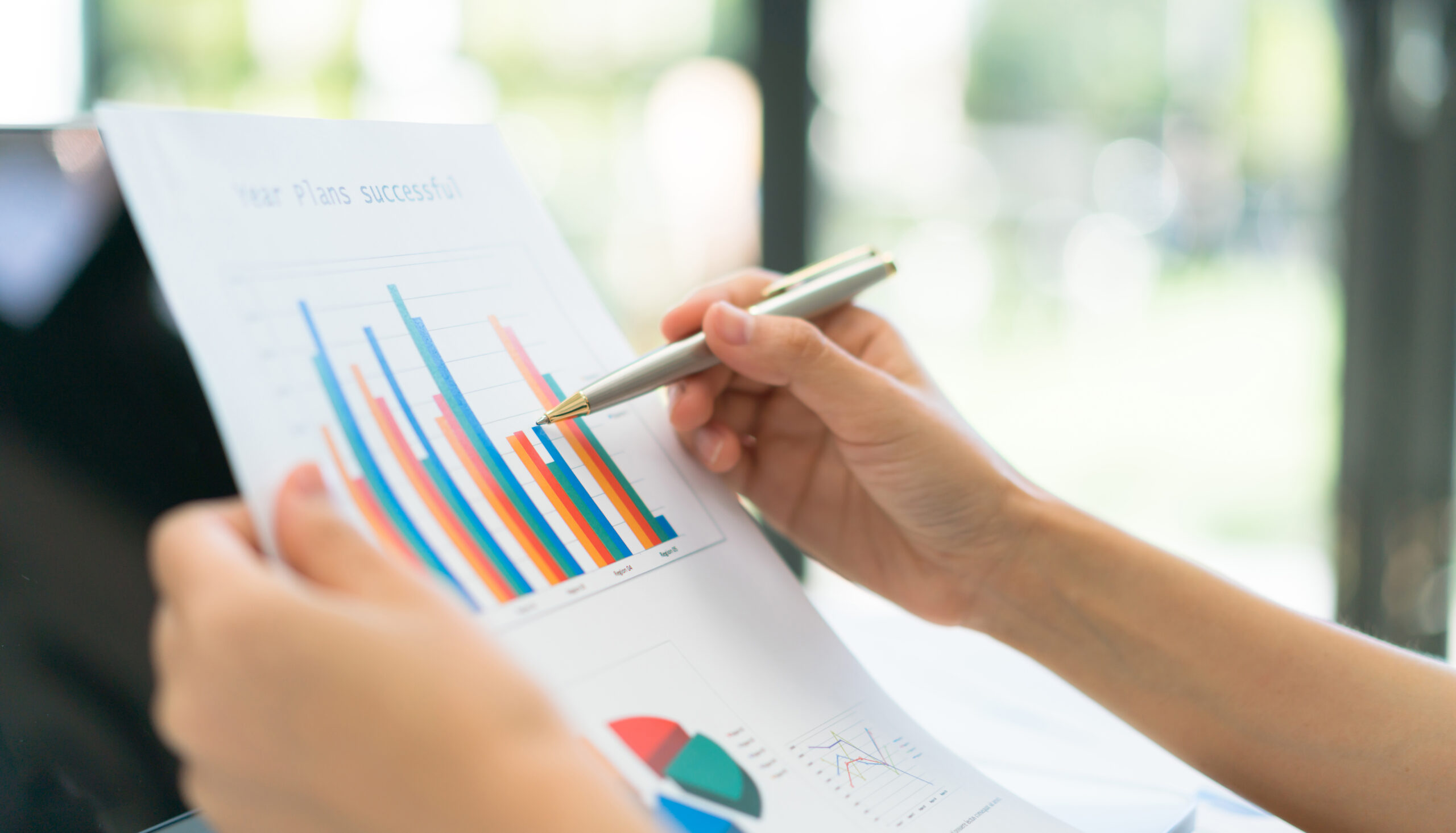 Business people using laptop and Financial charts at meeting off